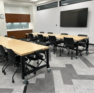 This room has four rectangular tables and 16 chairs.