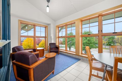 Room has a youth size round table with 4 chairs, plus three comfortable chairs.