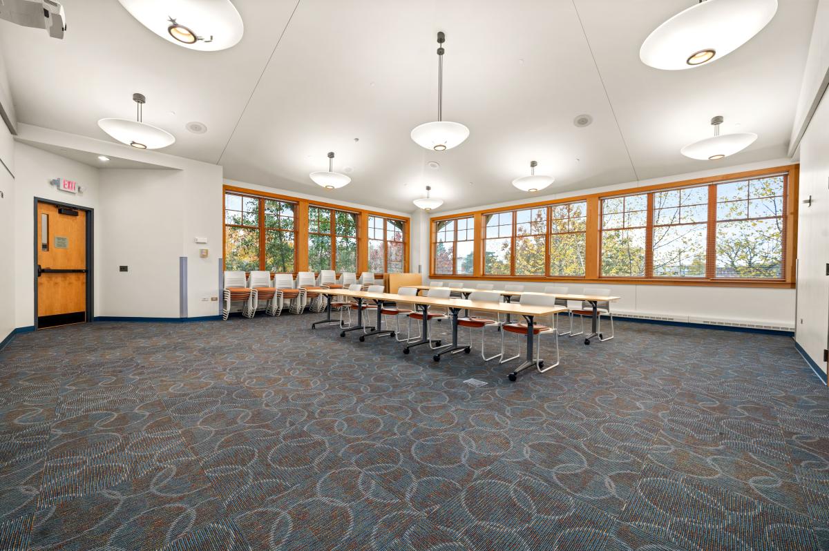 Large room with 9 rectangular tables. 